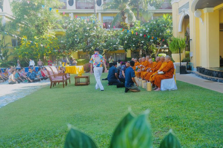 Staff attending a Songkran Buddhist ceremony with monks at a resort in Patong Beach Phuket Thailand